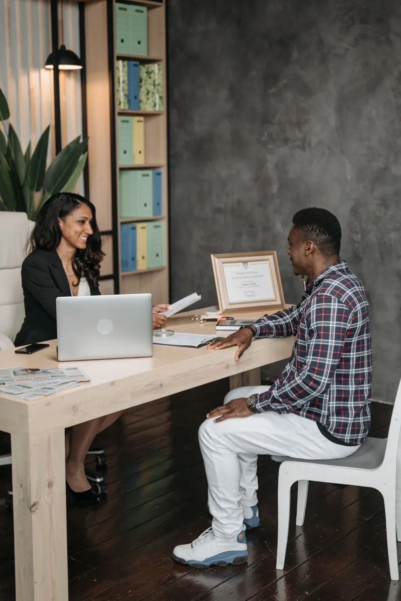 A lawyer and client talking across an office desk